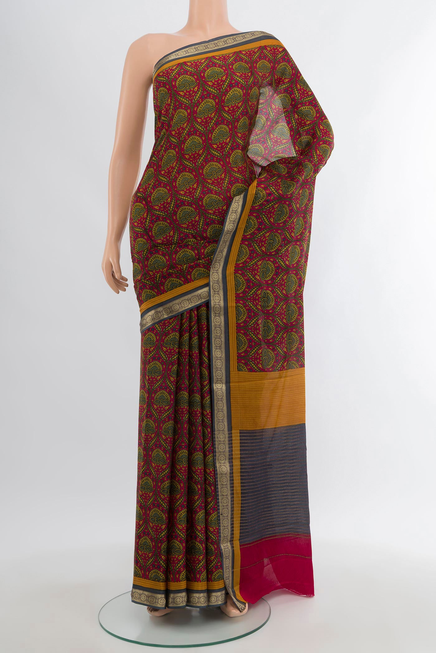 Maroon Crepe Saree with Floral Print on the body and Zari Border.  displayed on a mannequin