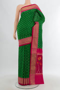 Green Pochampally Saree with Pure Ikat on the body and Zari Border.  displayed on a mannequin