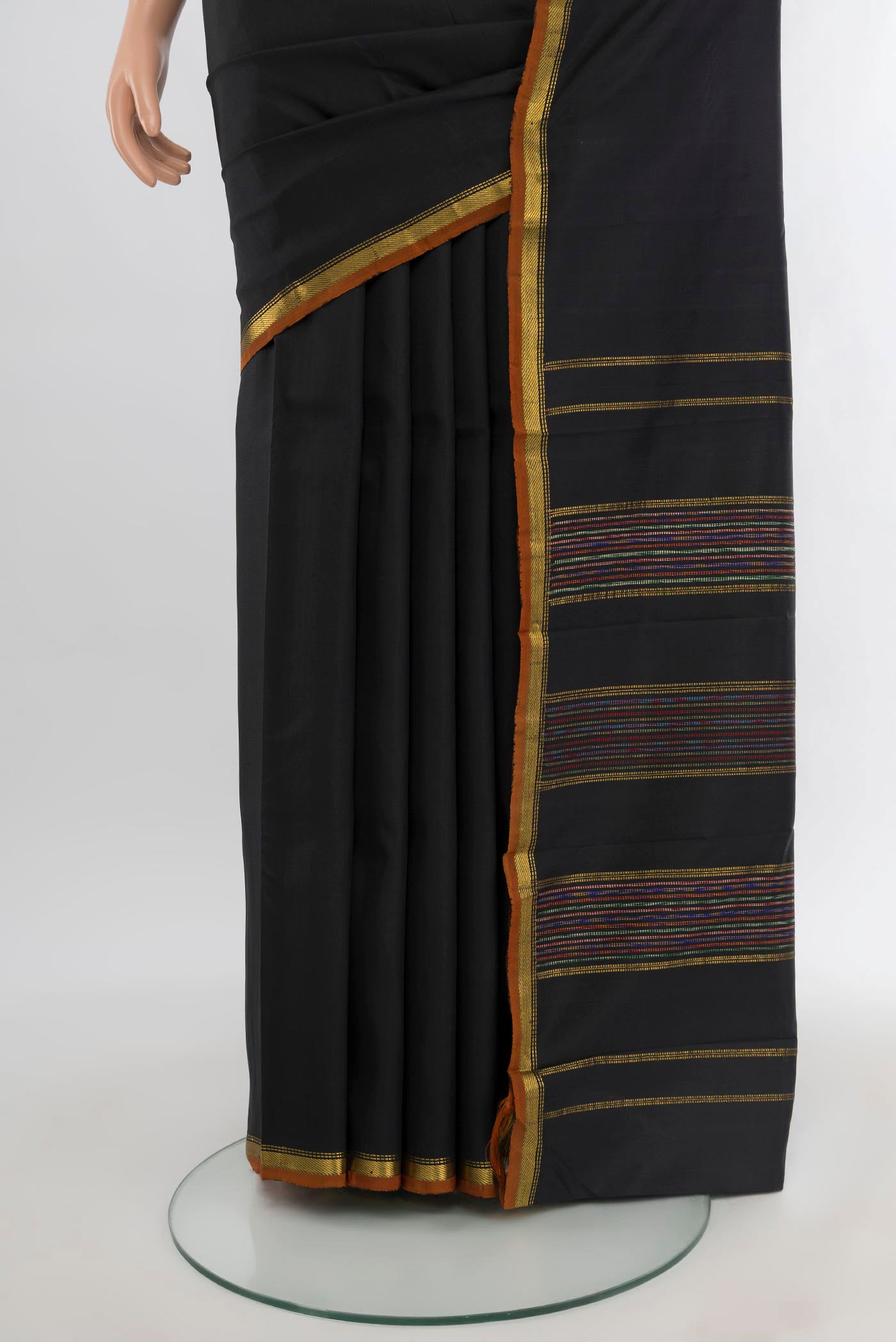 Pleats and pallu of Black Kanchipuram Silk Saree with Plain Body and Zari Border. 