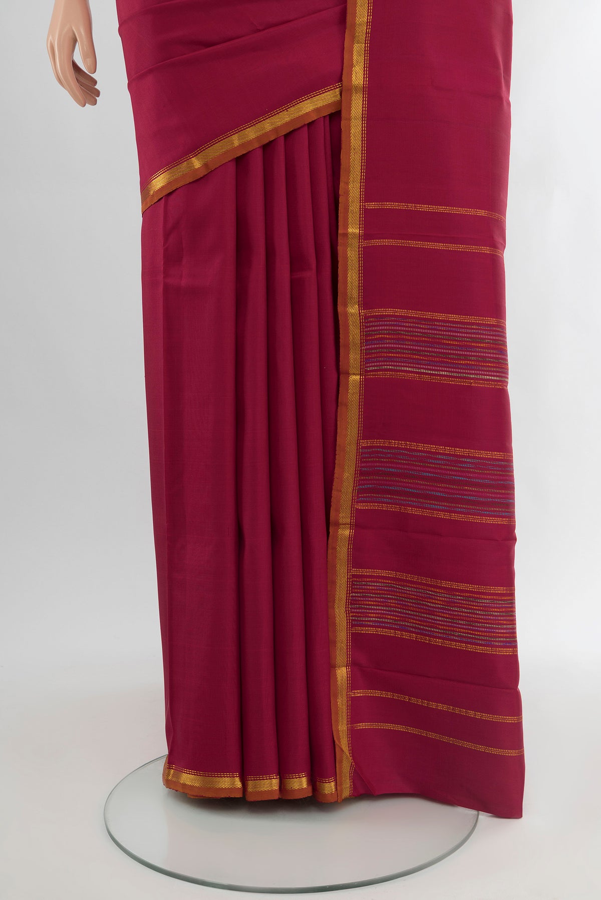 Pleats and pallu of Maroon Kanchipuram Silk Saree with Plain Body and Zari Border. 