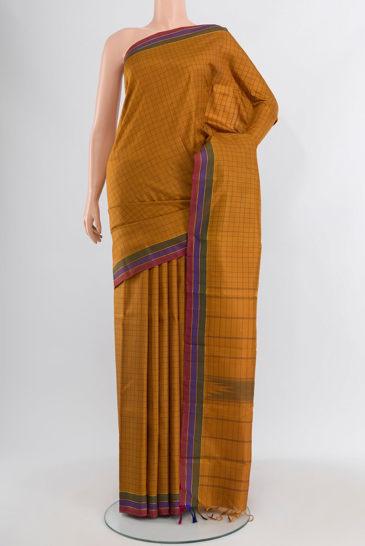 Mustard Kanchipuram Silk Saree with Checked design on the body and Plain Border.  displayed on a mannequin