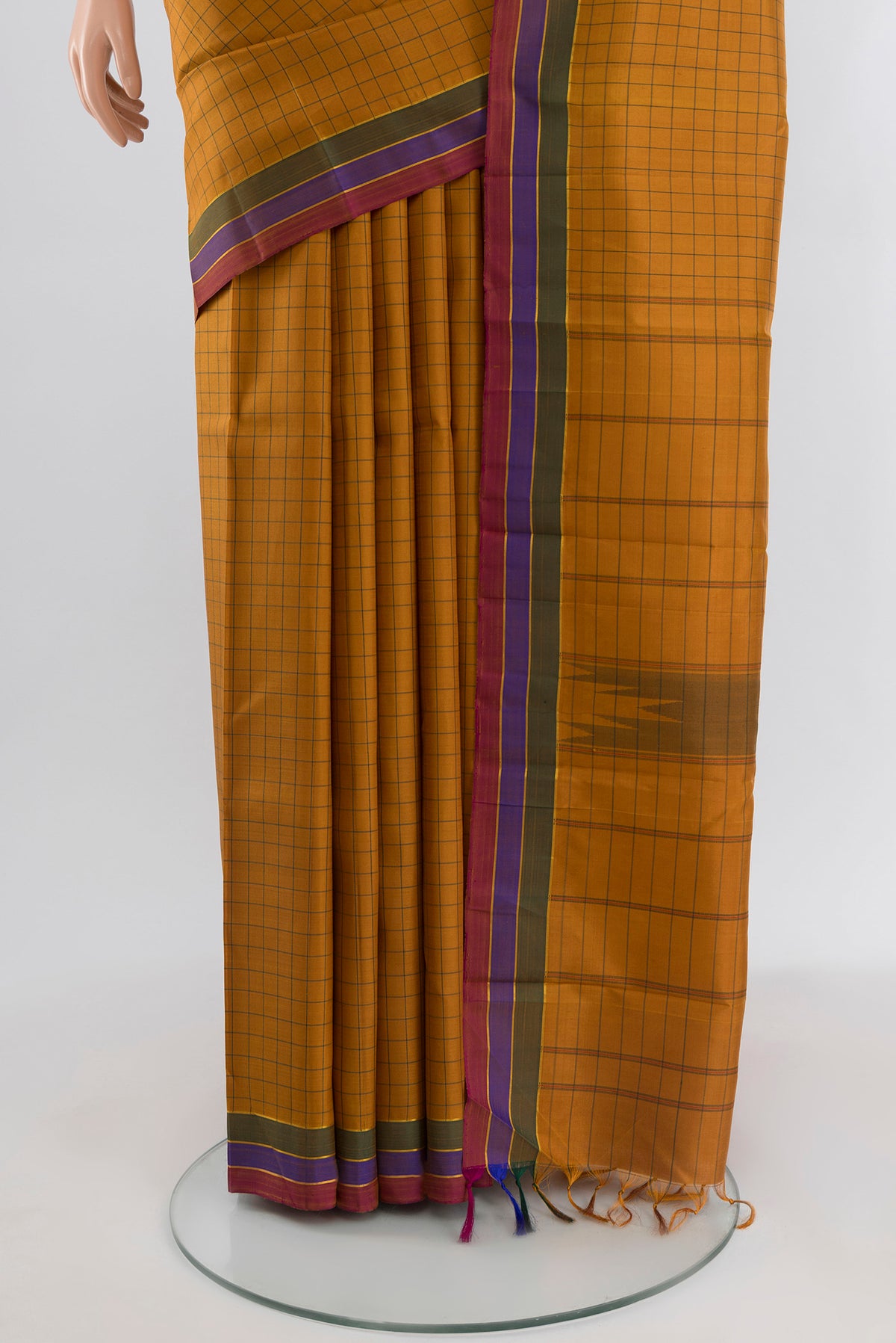 Pleats and pallu of Mustard Kanchipuram Silk Saree with Checked design on the body and Plain Border. 