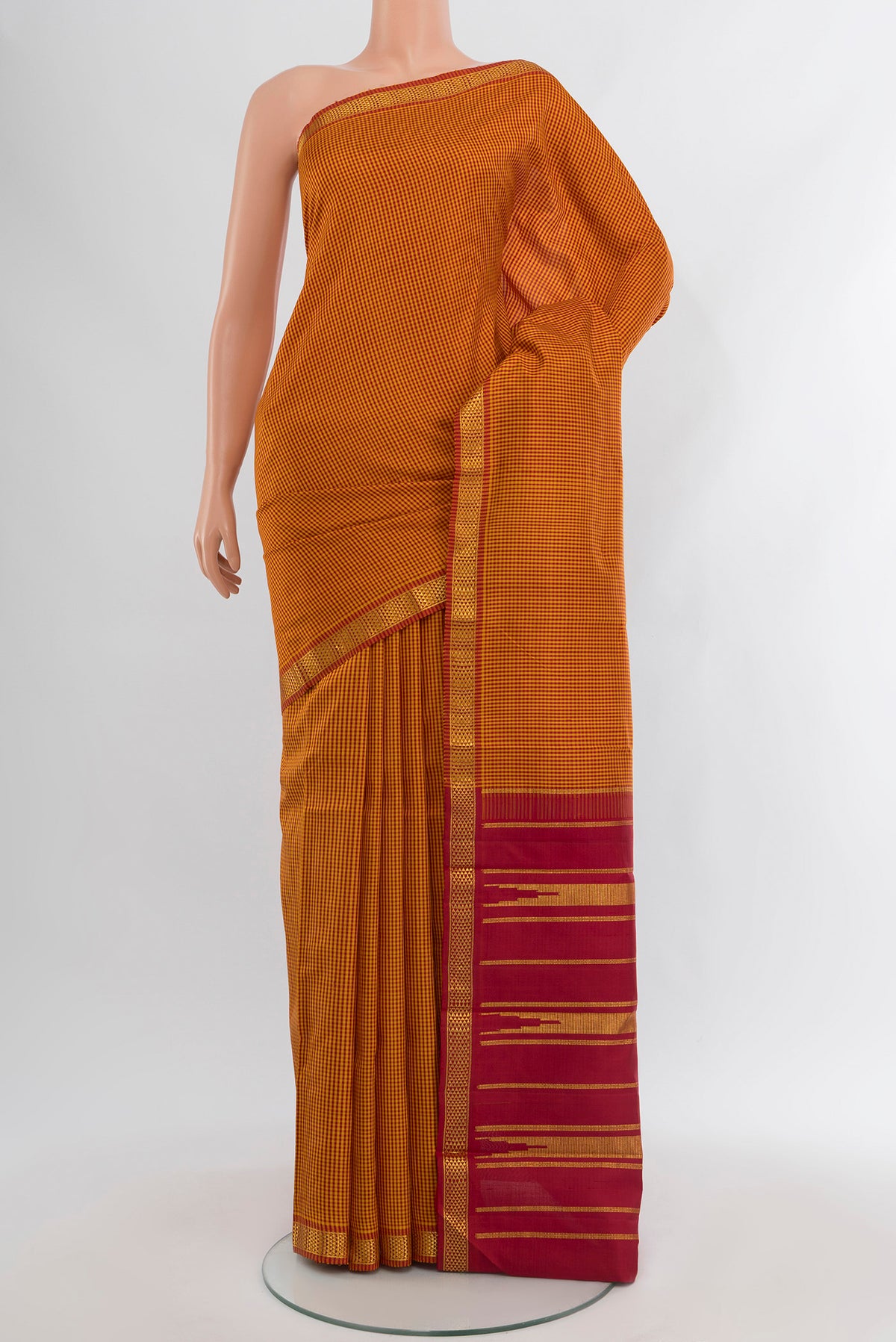 Multi Color Kanchipuram Silk Saree with Checked design on the body and Zari Border.  displayed on a mannequin