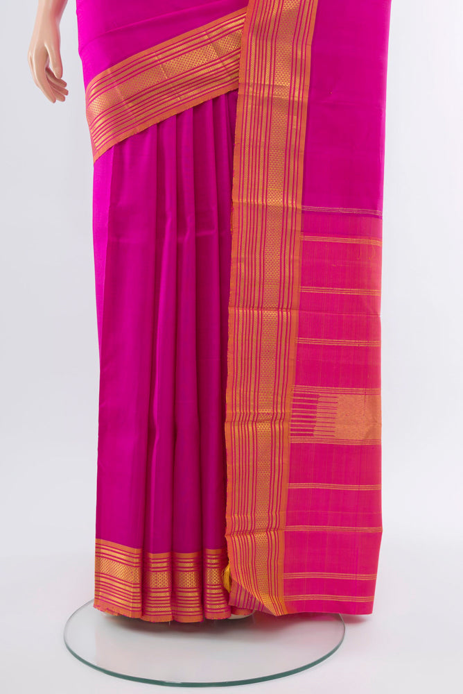 Pleats and pallu of Rani Pink Kanchipuram Silk Saree with Zari Butta on the body and Silk Border. 
