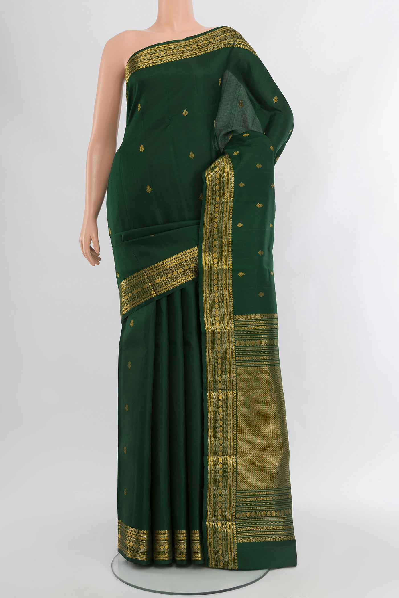 Bottle Green Kanjivaram Silk Saree with Zari Butta on the body and Zari Border.  displayed on a mannequin