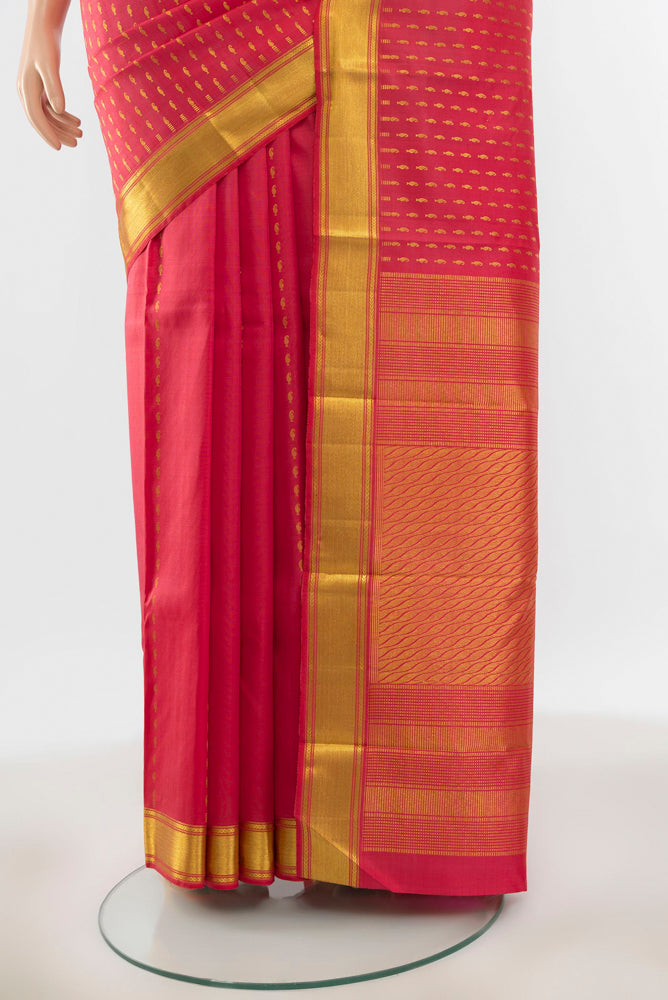 Pleats and pallu of Pure Silk Pure Zari Peach Kanjivaram Saree with Zari Butta on the body and Silk Border. 