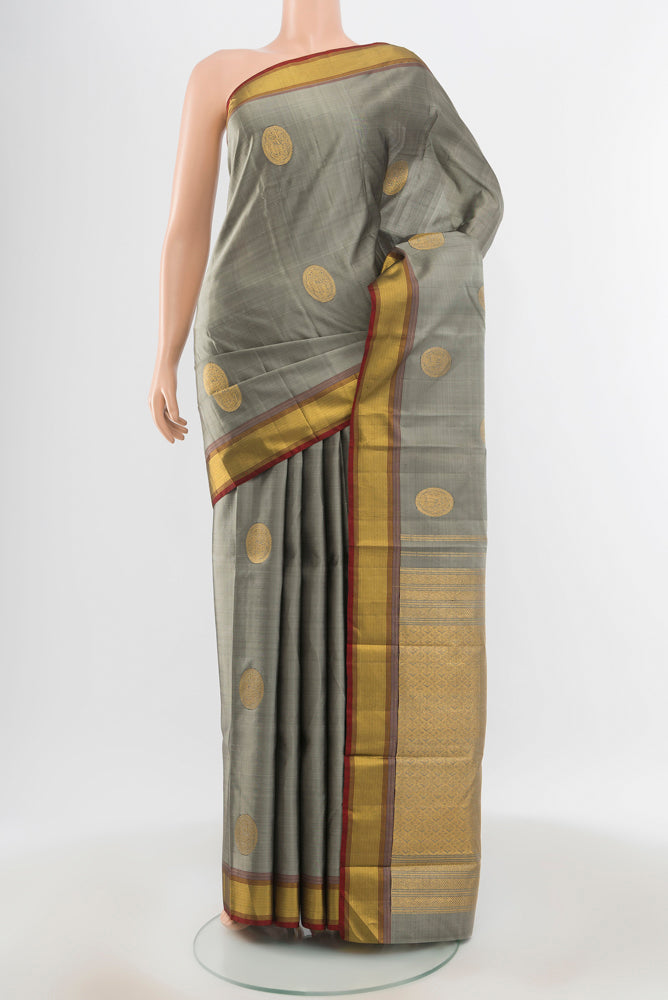 Pure Silk Pure Zari Davys Grey Kanjivaram Saree with Zari Butta on the body and Silk Border.  displayed on a mannequin