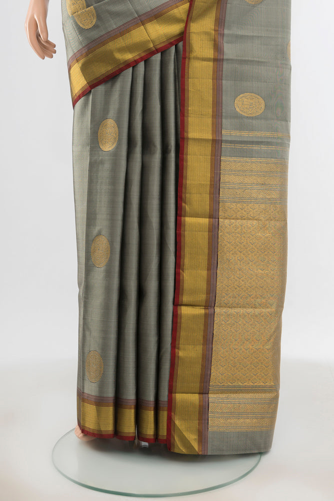 Pleats and pallu of Pure Silk Pure Zari Davys Grey Kanjivaram Saree with Zari Butta on the body and Silk Border. 