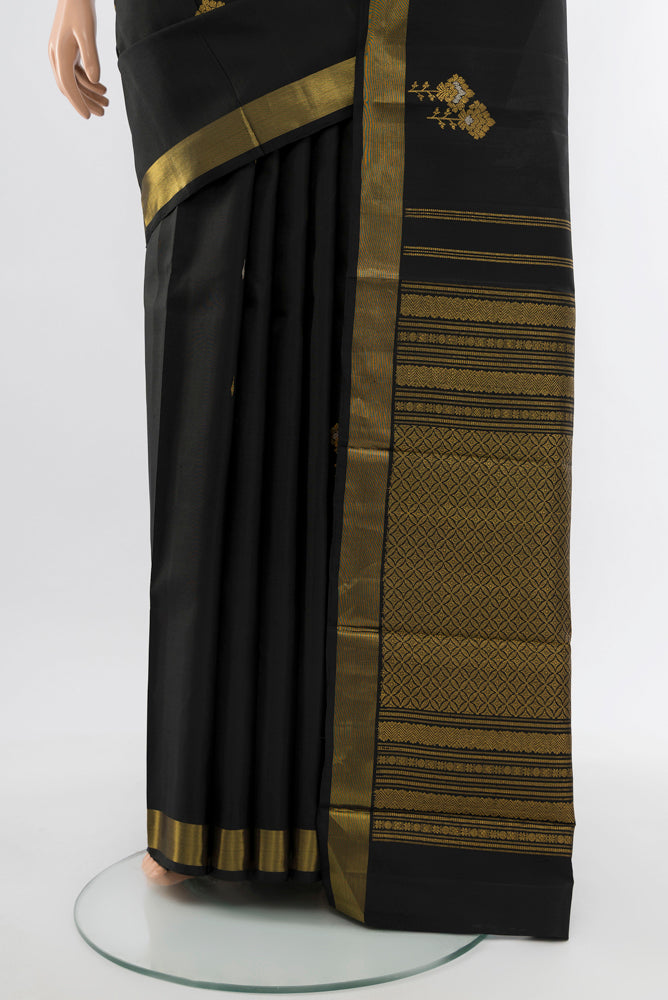 Pleats and pallu of Black Kanjivaram Silk Saree with Zari Butta on the body and Silk Border. 