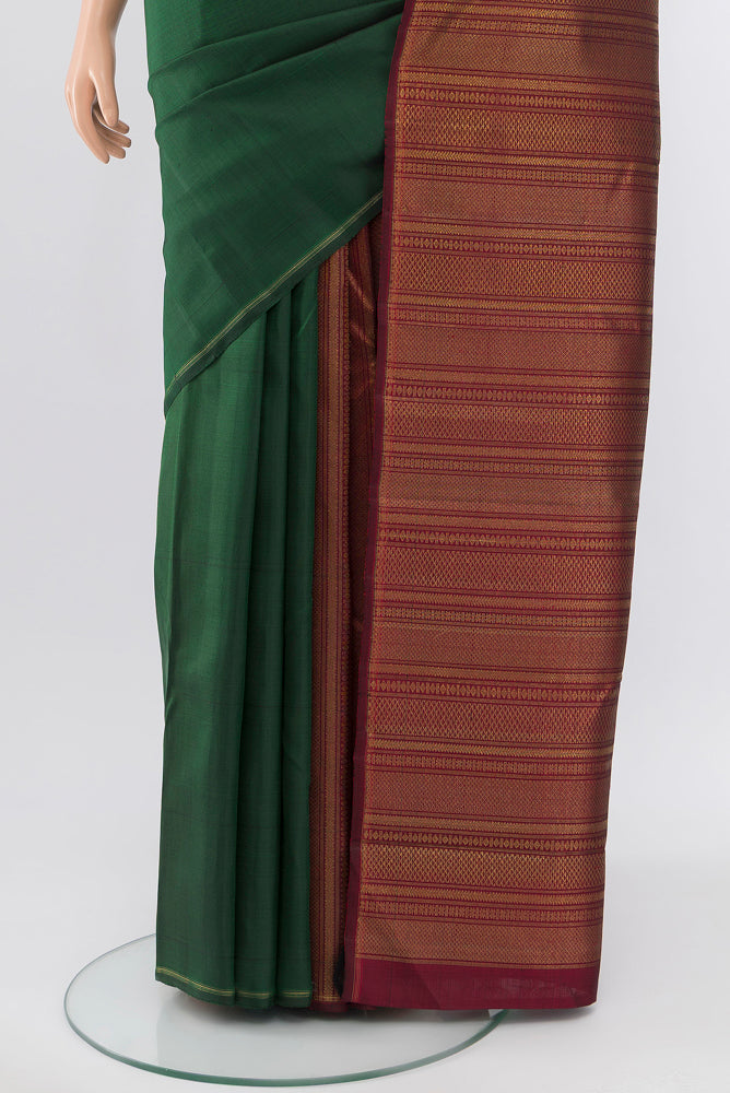 Pleats and pallu of Pure Silk Pure Zari Bottle Green Kanjivaram Saree with Zari Butta on the body and Silk Border. 