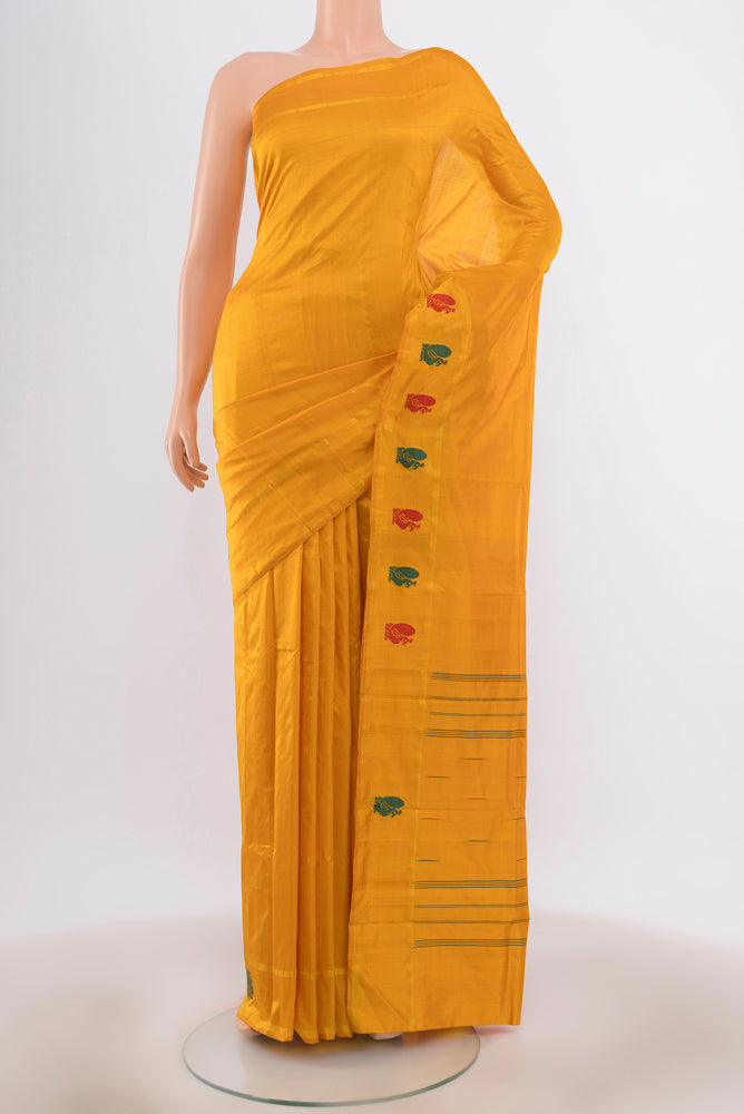 Yellow Kanchipuram Silk Saree with Zari Butta on the body and Silk Border.  displayed on a mannequin