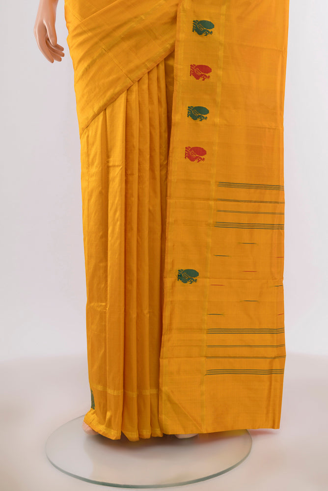 Pleats and pallu of Yellow Kanchipuram Silk Saree with Zari Butta on the body and Silk Border. 
