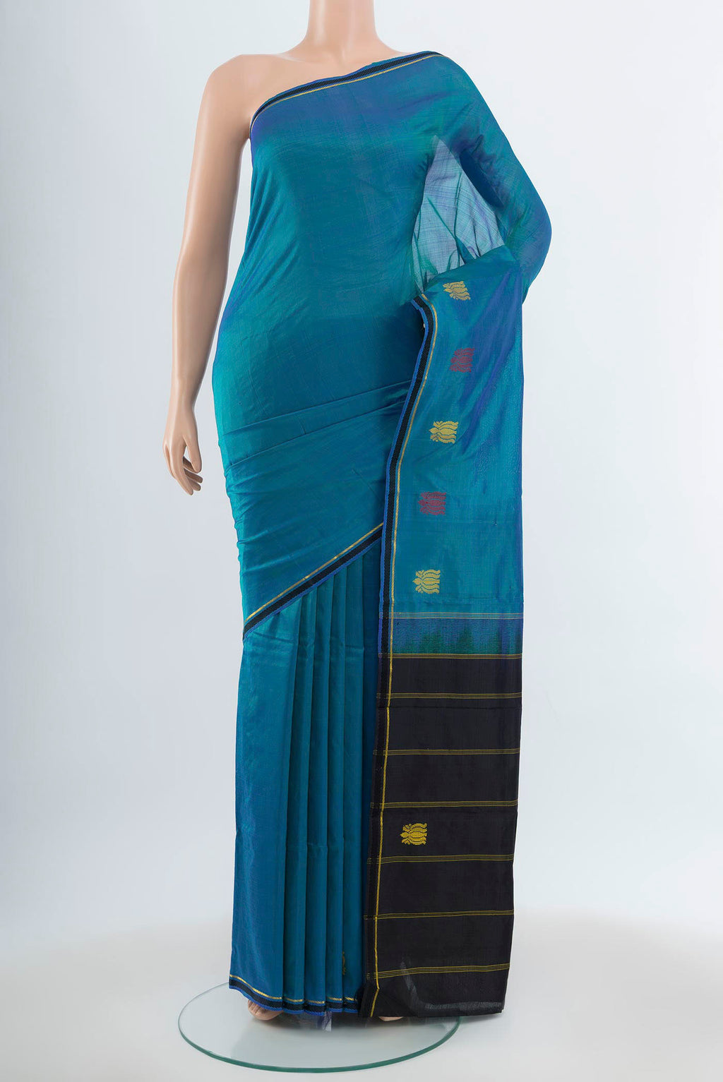 Peacock Blue Kanchipuram Silk Saree with Zari Butta on the body and Silk Border.  displayed on a mannequin