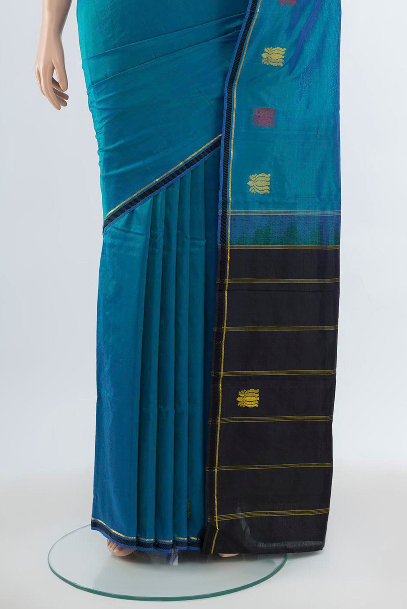 Pleats and pallu of Peacock Blue Kanchipuram Silk Saree with Zari Butta on the body and Silk Border. 