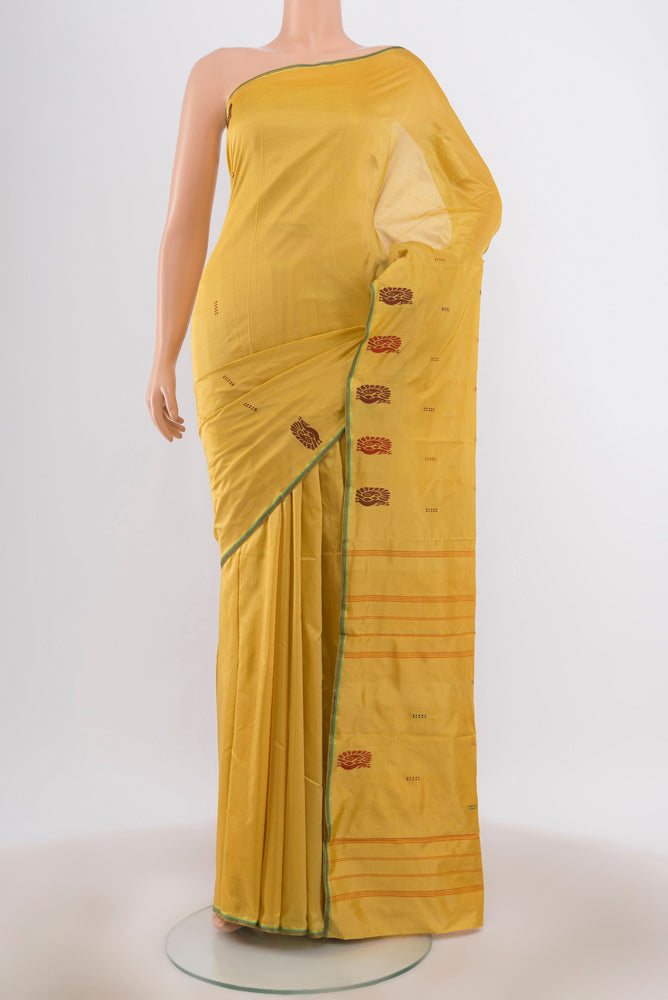 Golden Kanchipuram Silk Saree with Zari Butta on the body and Silk Border.  displayed on a mannequin