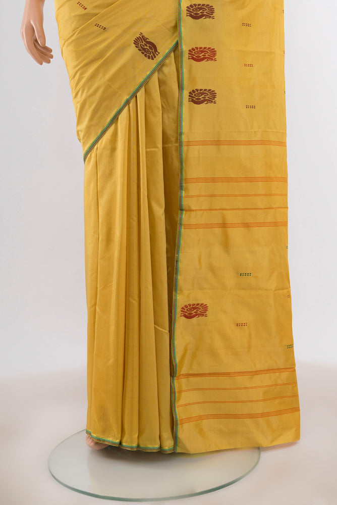 Pleats and pallu of Golden Kanchipuram Silk Saree with Zari Butta on the body and Silk Border. 