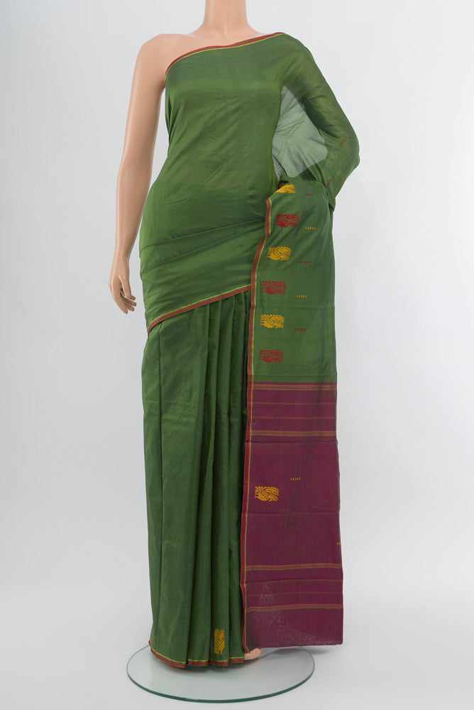 Light Green Kanchipuram Silk Saree with Plain Body and Zari Border.  displayed on a mannequin