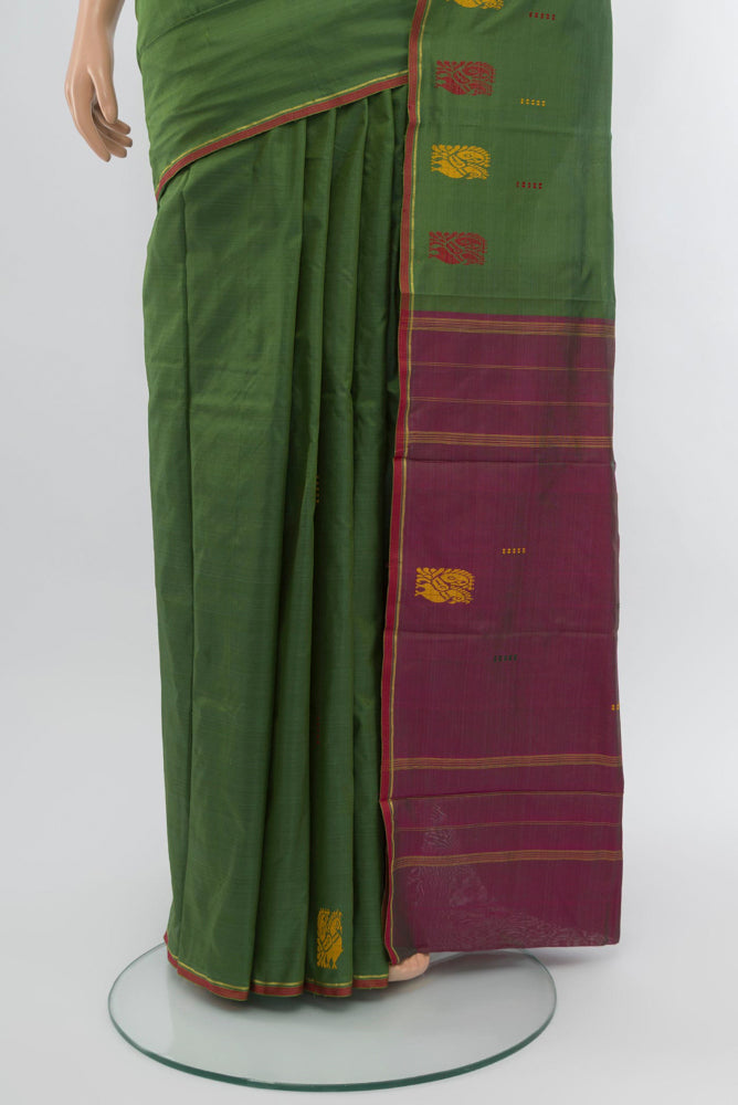 Pleats and pallu of Light Green Kanchipuram Silk Saree with Plain Body and Zari Border. 