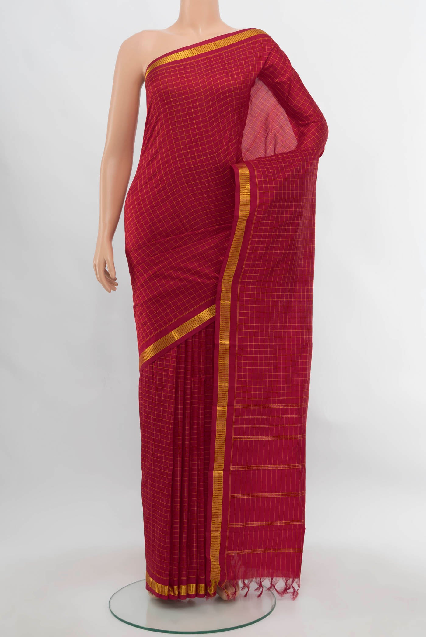 Maroon Kanchipuram Silk Saree with Checked design on the body and Silk Border.  displayed on a mannequin