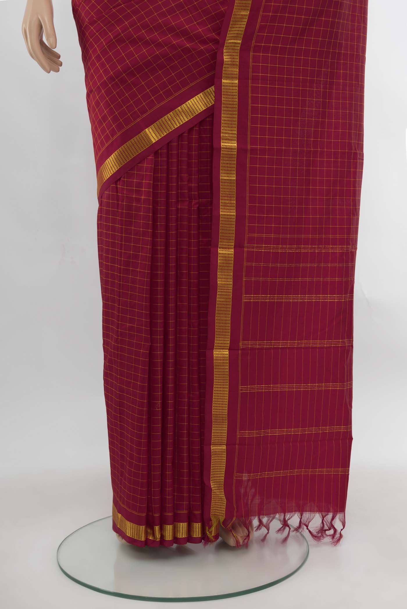 Pleats and pallu of Maroon Kanchipuram Silk Saree with Checked design on the body and Silk Border. 