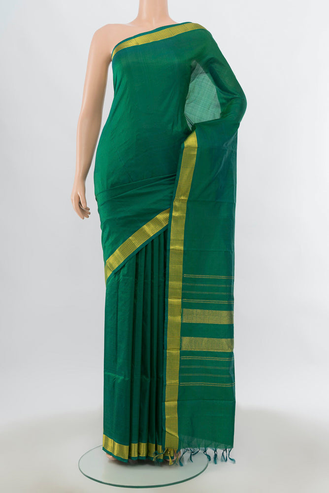 Mint Green Kanjivaram Silk Saree with Zari Butta on the body and Silk Border.  displayed on a mannequin