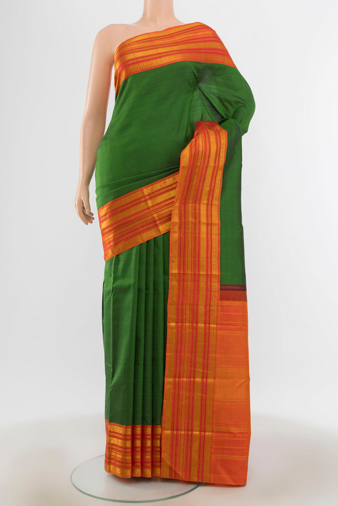 Mint Green Kanjivaram Silk Saree with Zari Butta on the body and Silk Border.  displayed on a mannequin