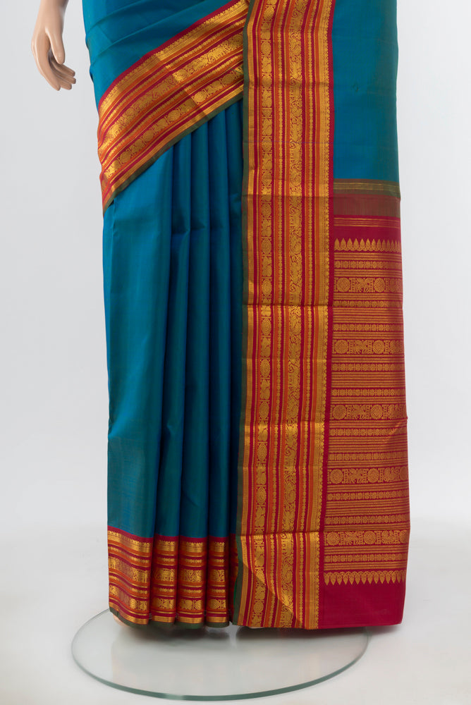 Pleats and pallu of Pure Silk Pure Zari Peacock Blue Kanjivaram Saree with Zari Butta on the body and Silk Border. 