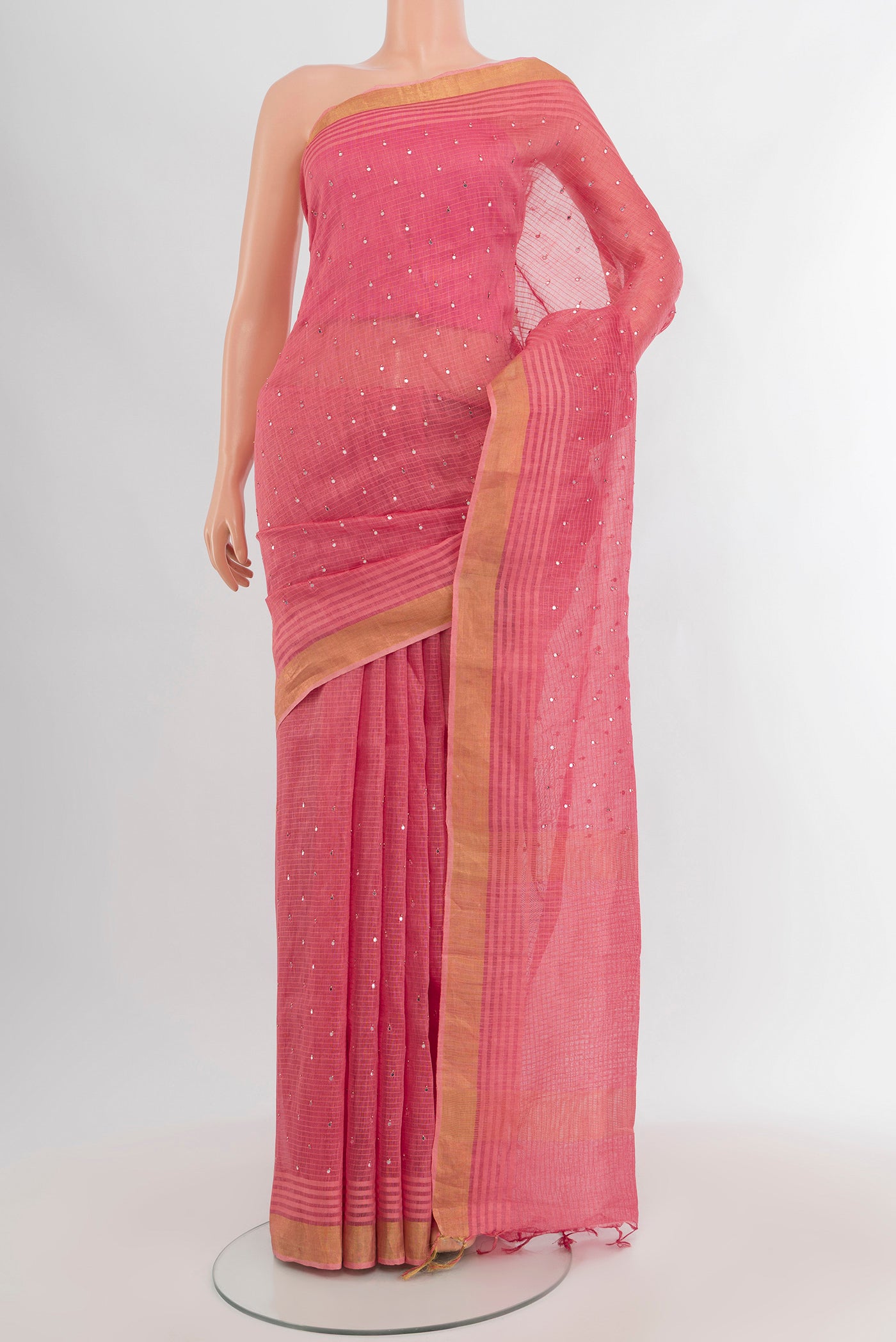 Rose pink Tussar Silk Saree with Embroidery on the body and Zari Border.  displayed on a mannequin