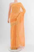 Peach Tussar Silk Saree with Embroidery on the body and Zari Border.  displayed on a mannequin