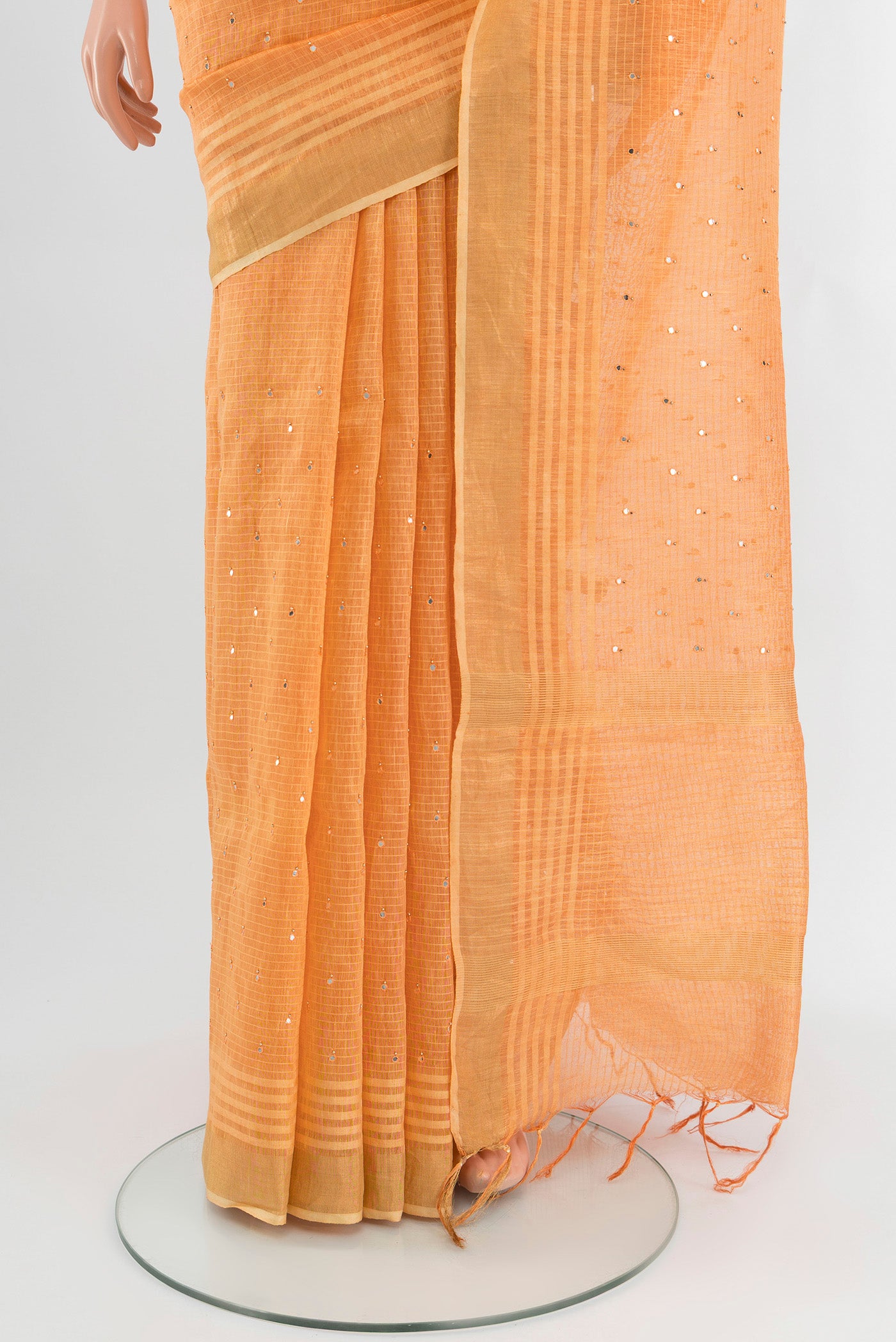Pleats and pallu of Peach Tussar Silk Saree with Embroidery on the body and Zari Border. 