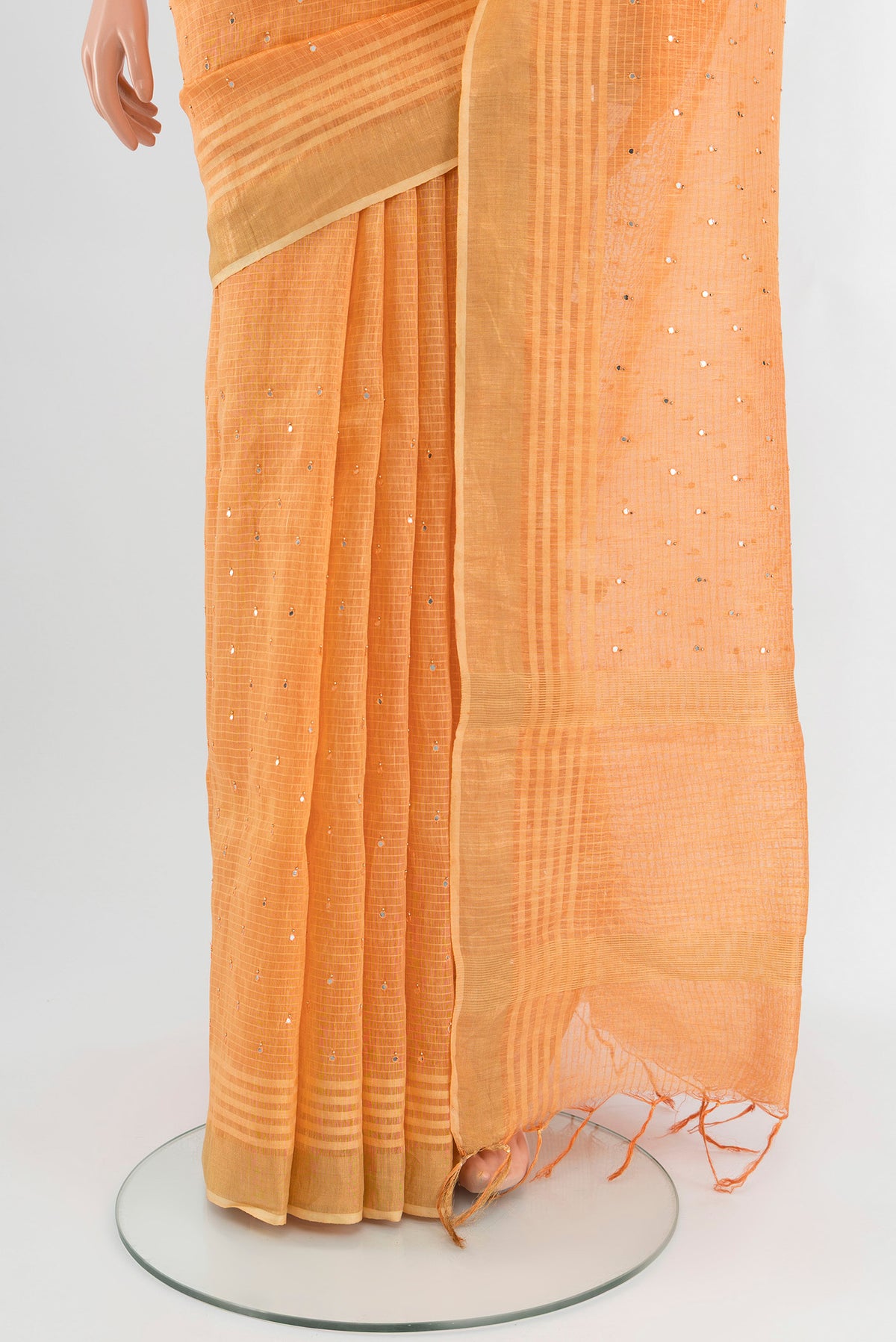 Pleats and pallu of Peach Tussar Silk Saree with Embroidery on the body and Zari Border. 