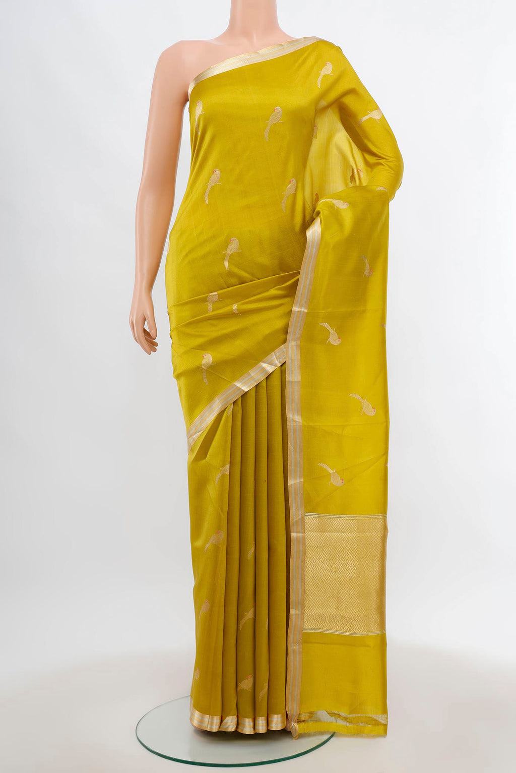 Pista Green Banarasi Katan Silk Saree with Zari Butta on the body and Silk Border.  displayed on a mannequin