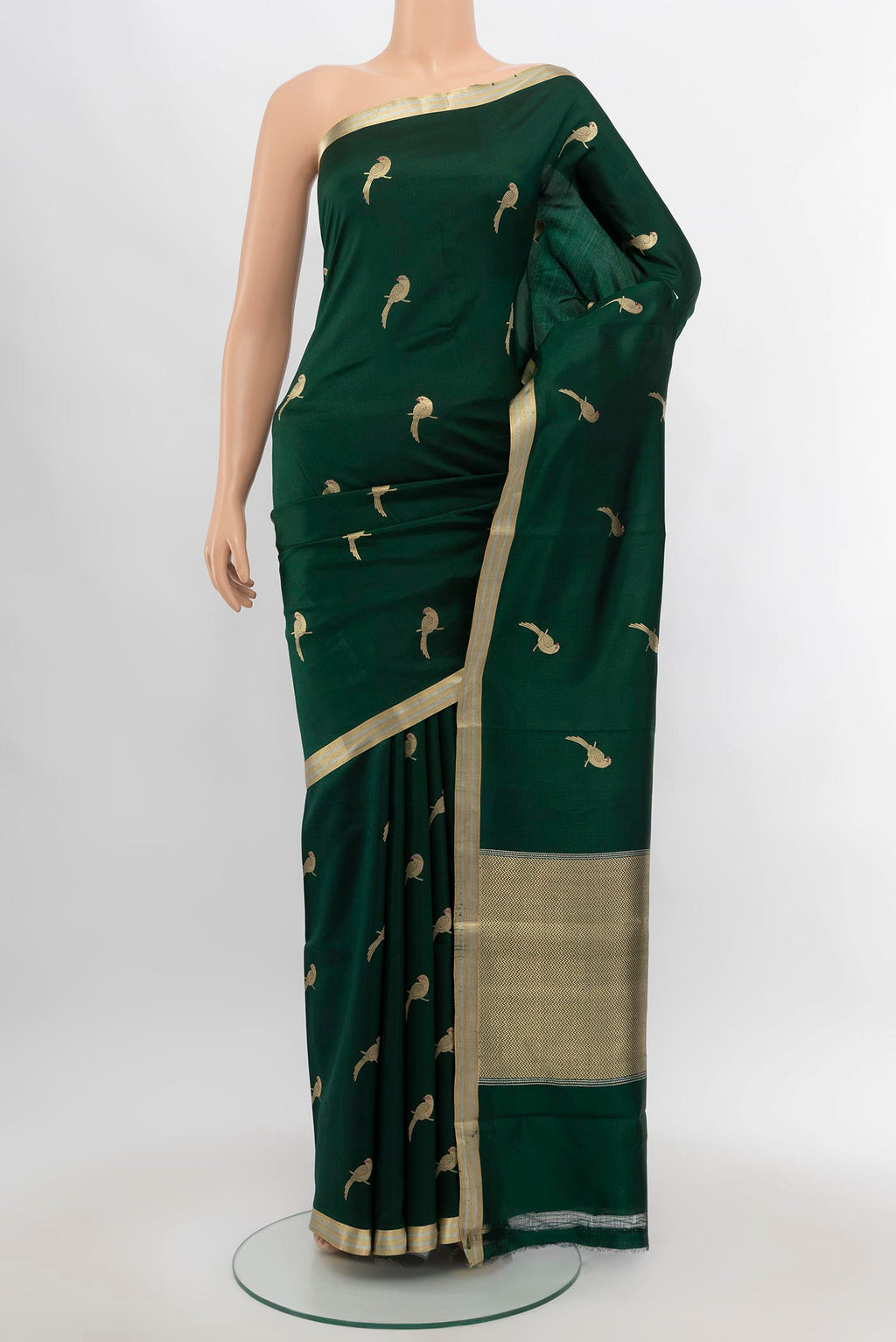 Bottle Green Banarasi Katan Silk Saree with Zari Butta on the body and Silk Border.  displayed on a mannequin
