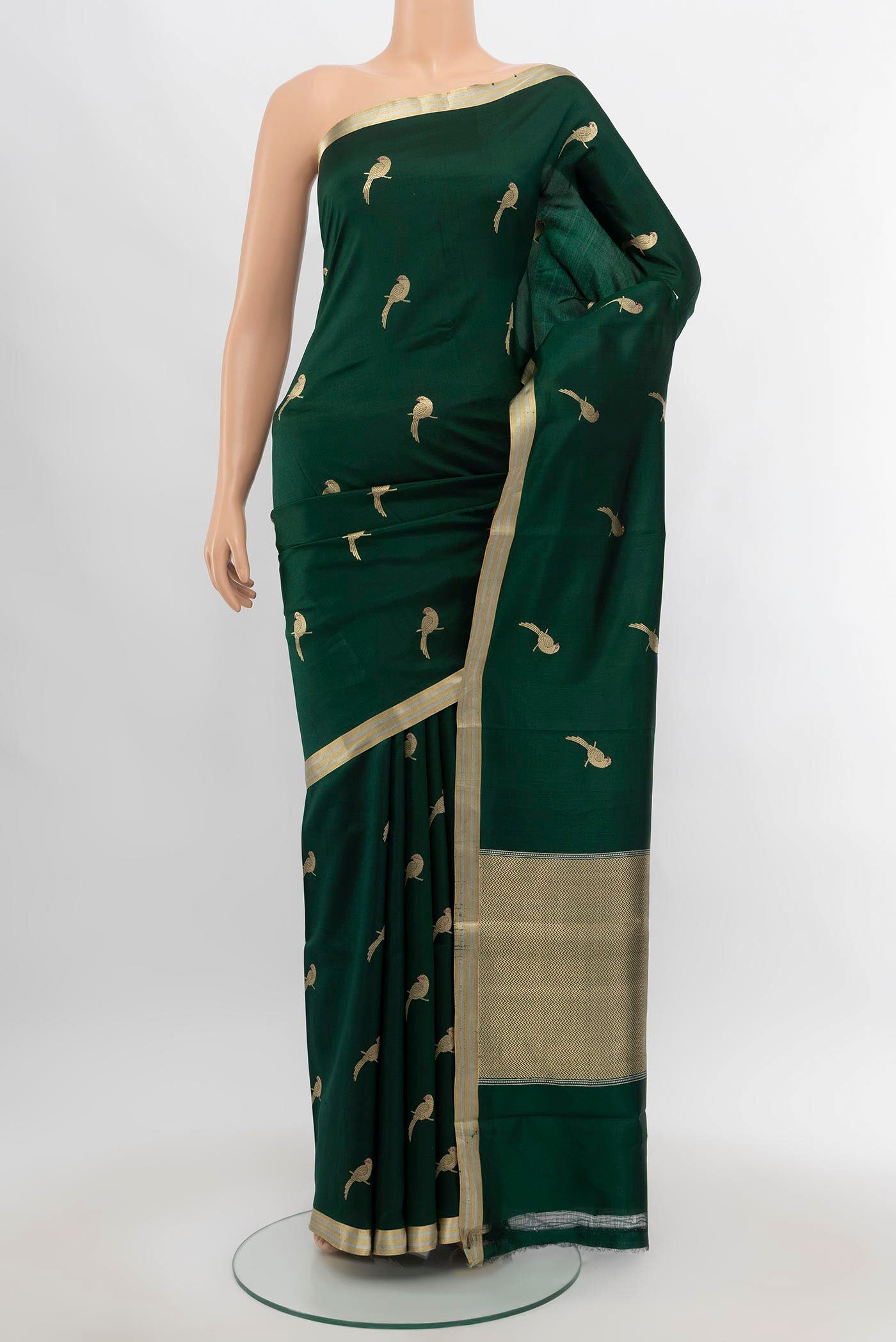 Bottle Green Banarasi Katan Silk Saree with Zari Butta on the body and Silk Border.  displayed on a mannequin