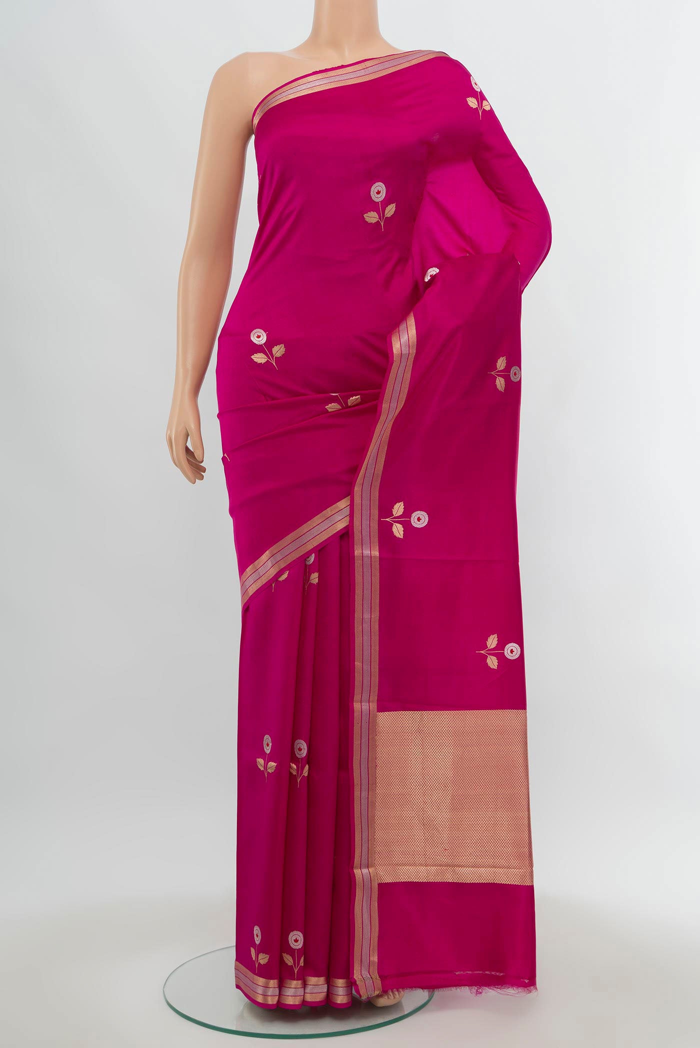 Rani Pink Banarasi Katan Silk Saree with Zari Butta on the body and Silk Border.  displayed on a mannequin