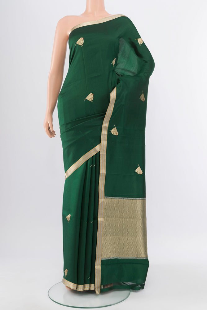 Bottle Green Banarasi Katan Silk Saree with Zari Butta on the body and Silk Border.  displayed on a mannequin