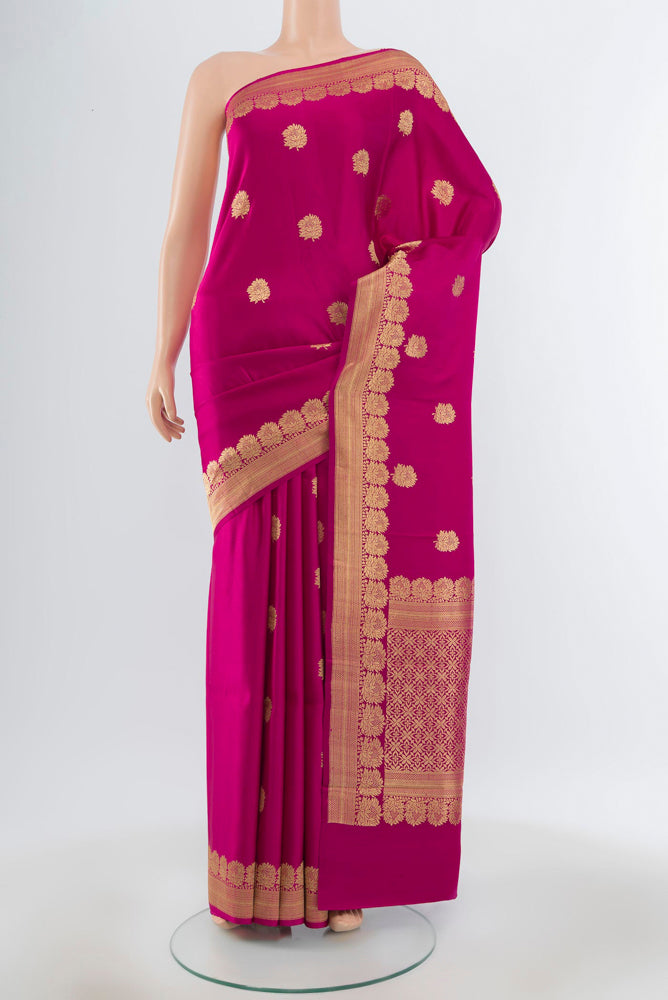 Pure Silk Pure Zari Dark Pink Banarasi Katan Saree with Zari Butta on the body and Silk Border.  displayed on a mannequin