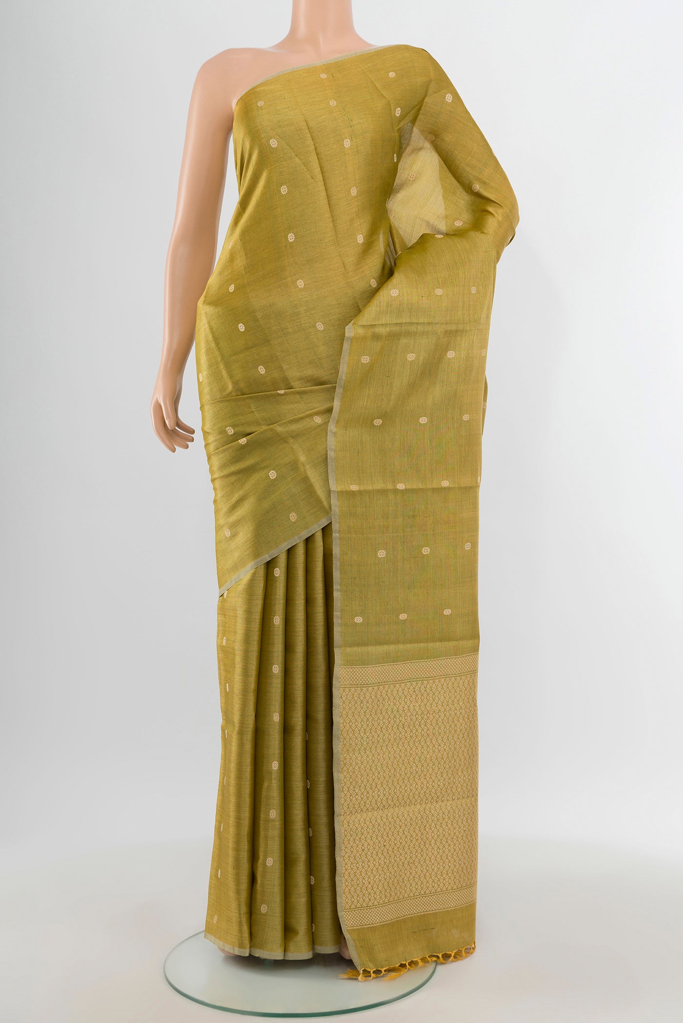 Golden Tussar Silk Saree with Zari Butta on the body and Zari Border.  displayed on a mannequin