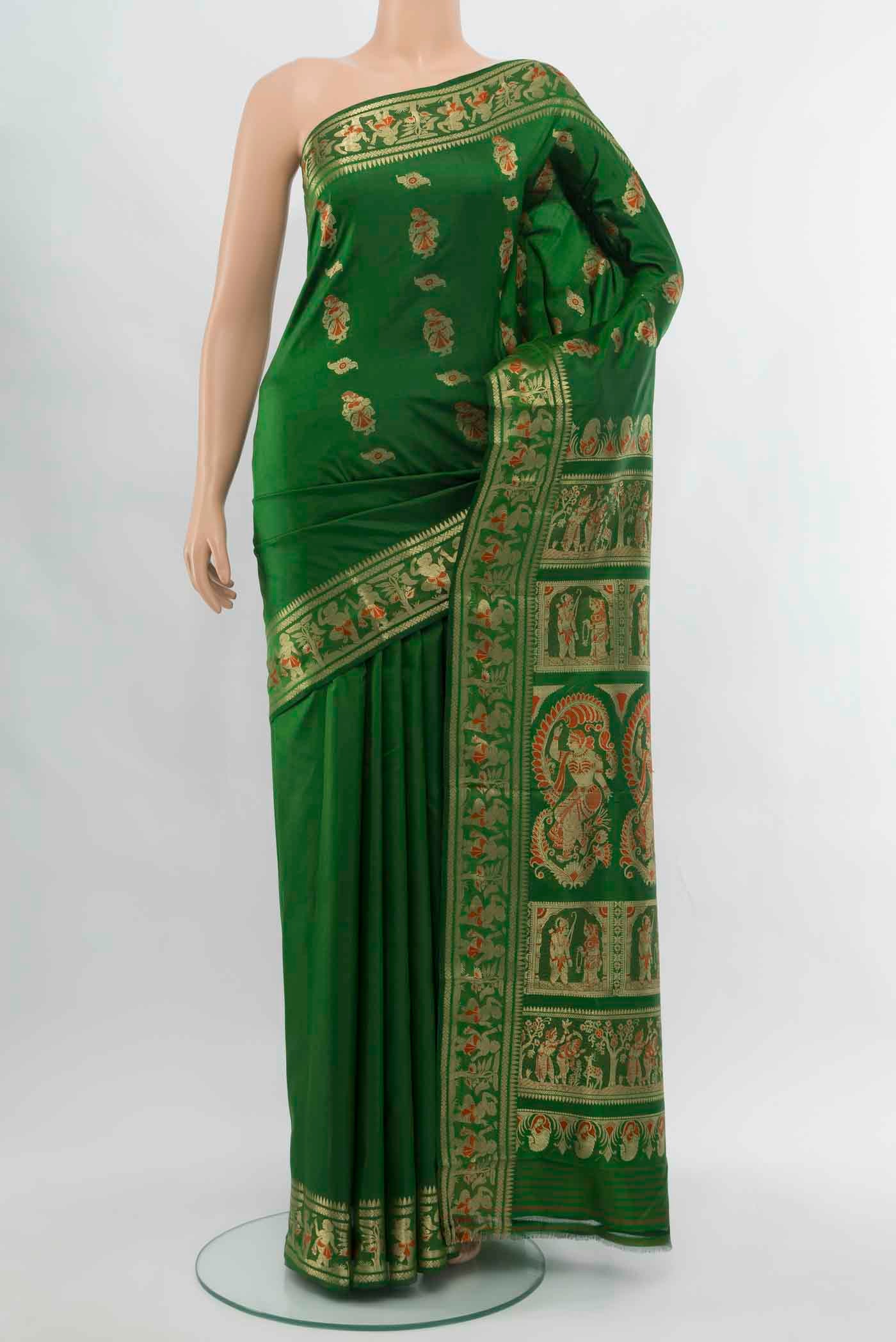 Bottle Green Baluchari Silk Saree with Zari Butta on the body and Silk Border.  displayed on a mannequin