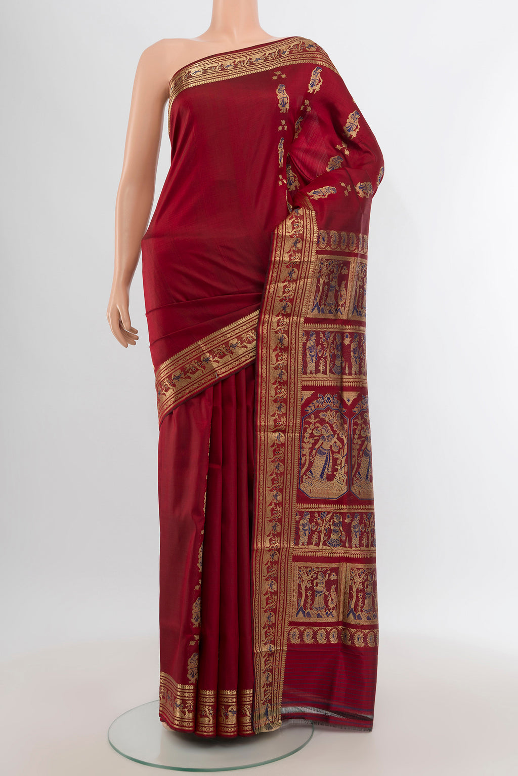 Maroon Baluchari Silk Saree with Zari And Thread Butta on the body and Zari Border.  displayed on a mannequin