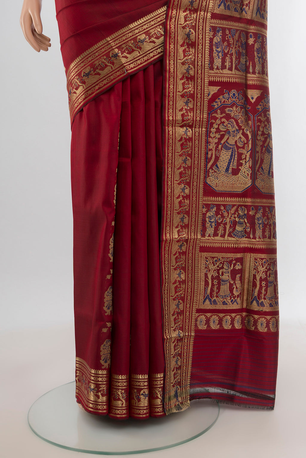 Pleats and pallu of Maroon Baluchari Silk Saree with Zari And Thread Butta on the body and Zari Border. 