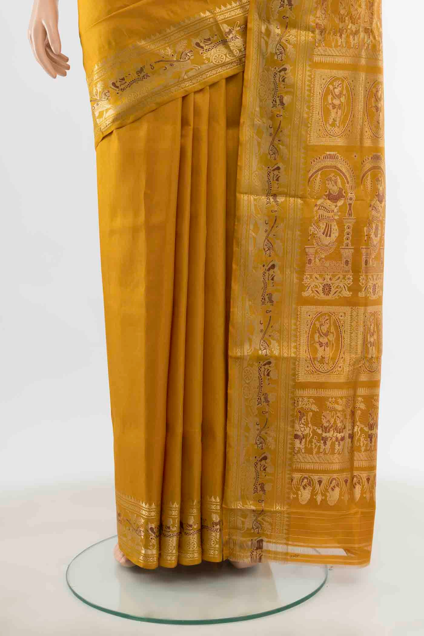 Pleats and pallu of Mustard Baluchari Silk Saree with Zari Butta on the body and Silk Border