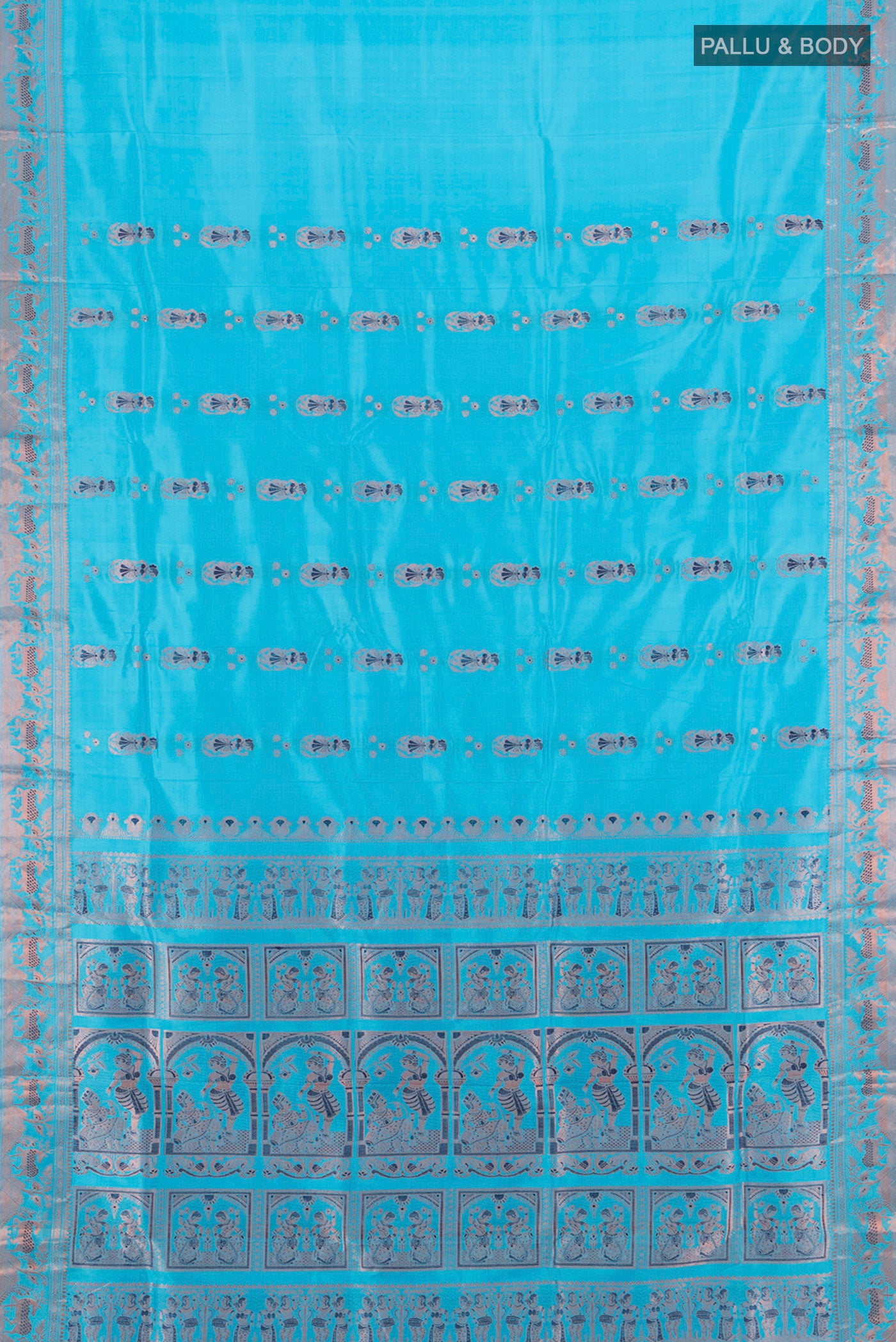 Flat view of Light Blue Baluchari Silk Saree with Zari And Thread Butta on the body and Zari Border. 