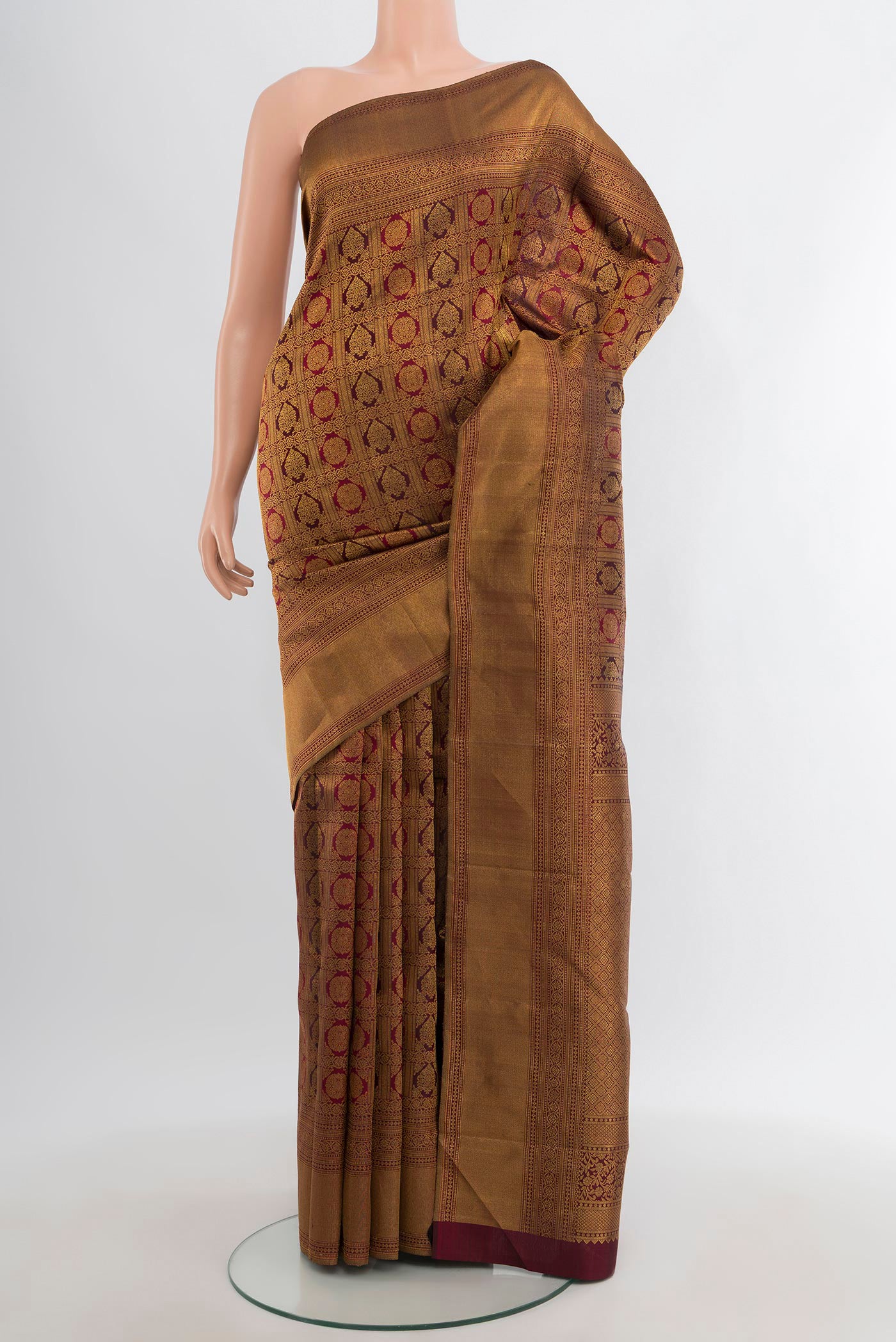 Maroon Kanjivaram Silk Saree with Zari Brocade on the body and Zari Border.  displayed on a mannequin