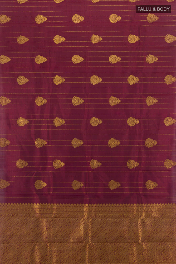Flat view of Maroon Kanjivaram Silk Saree with Zari Butta on the body and Silk Border. 