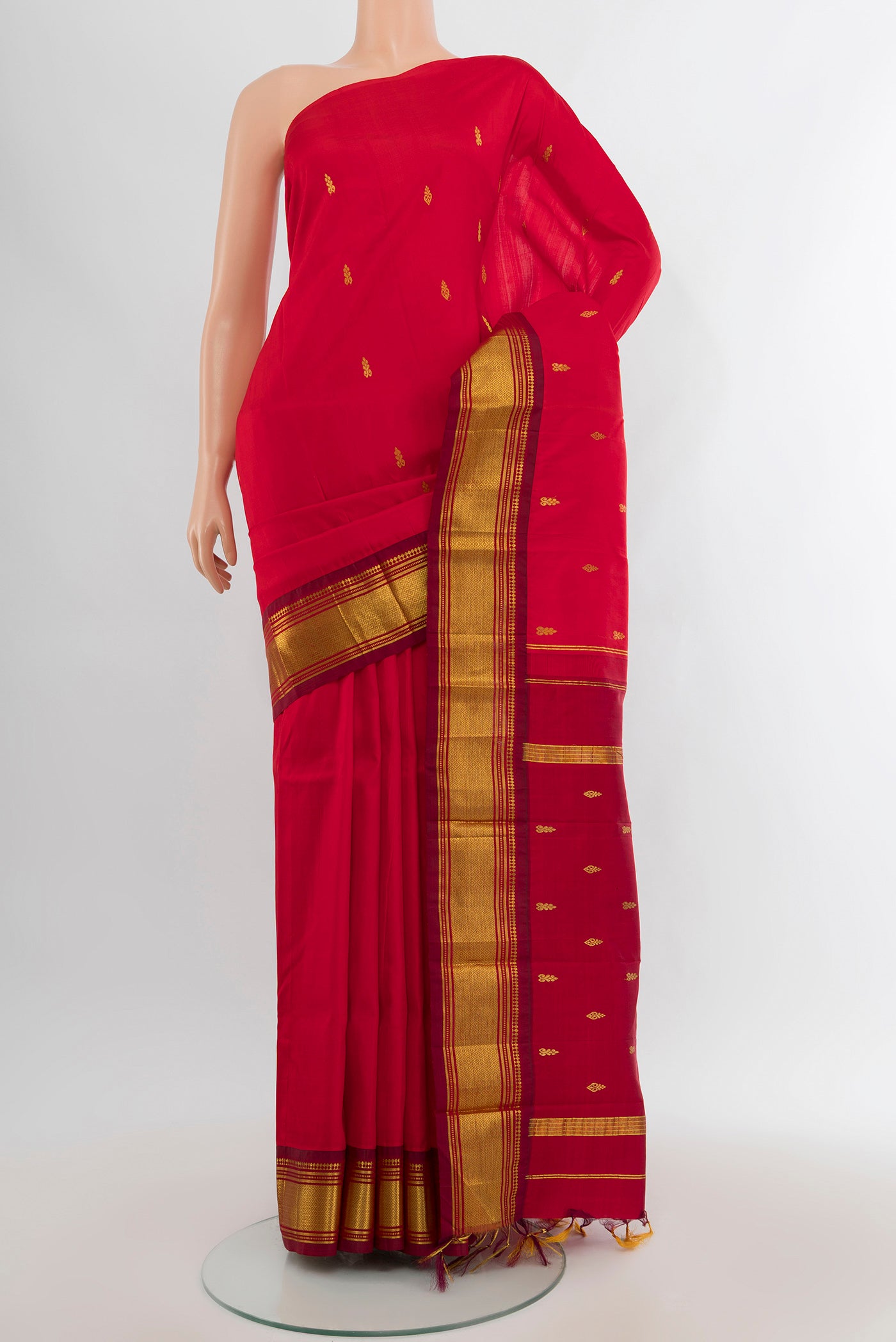 Red Kanjivaram Silk Saree with Zari Butta on the body and One Side Border.  displayed on a mannequin