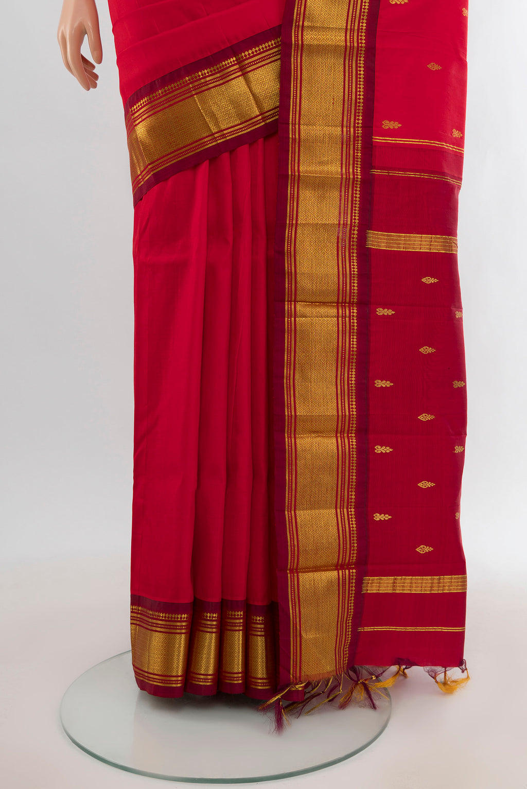 Pleats and pallu of Red Kanjivaram Silk Saree with Zari Butta on the body and One Side Border. 