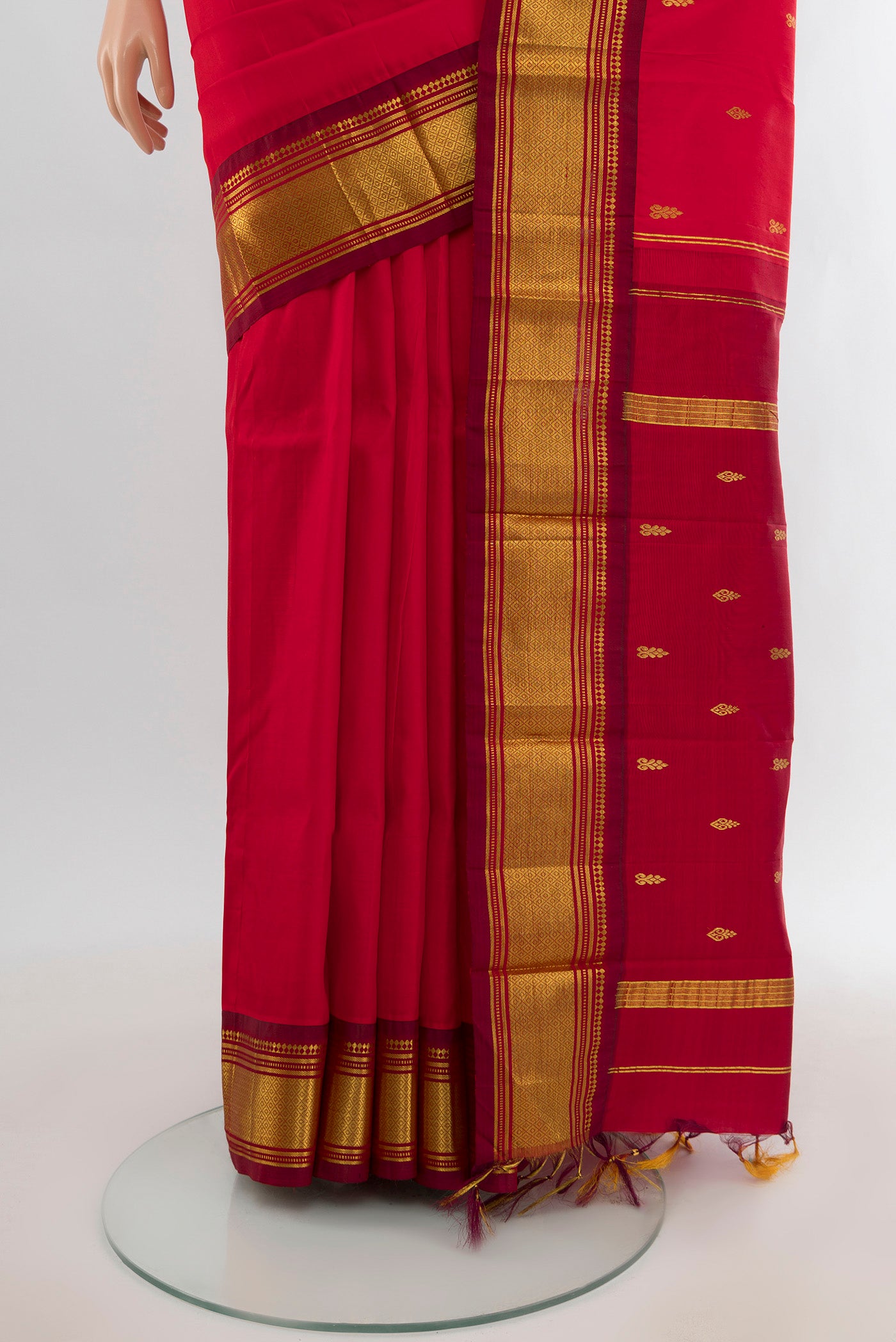 Pleats and pallu of Red Kanjivaram Silk Saree with Zari Butta on the body and One Side Border. 