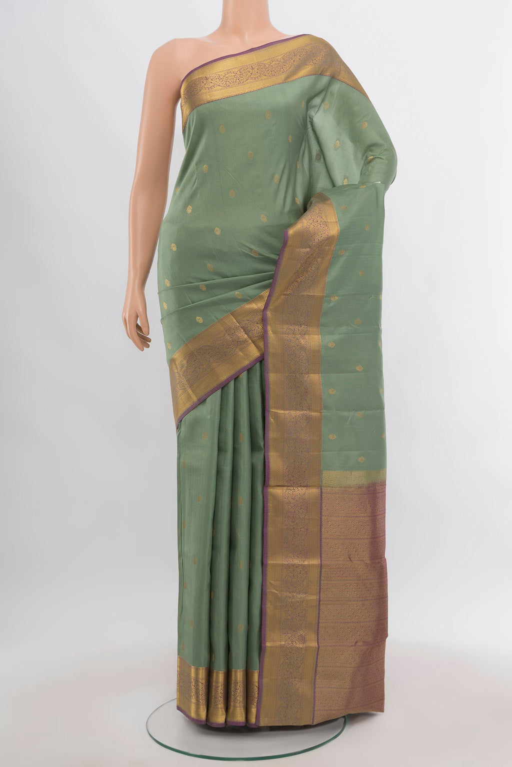 Pista Green Kanchipuram Silk Saree with Zari Butta on the body and Silk Border.  displayed on a mannequin