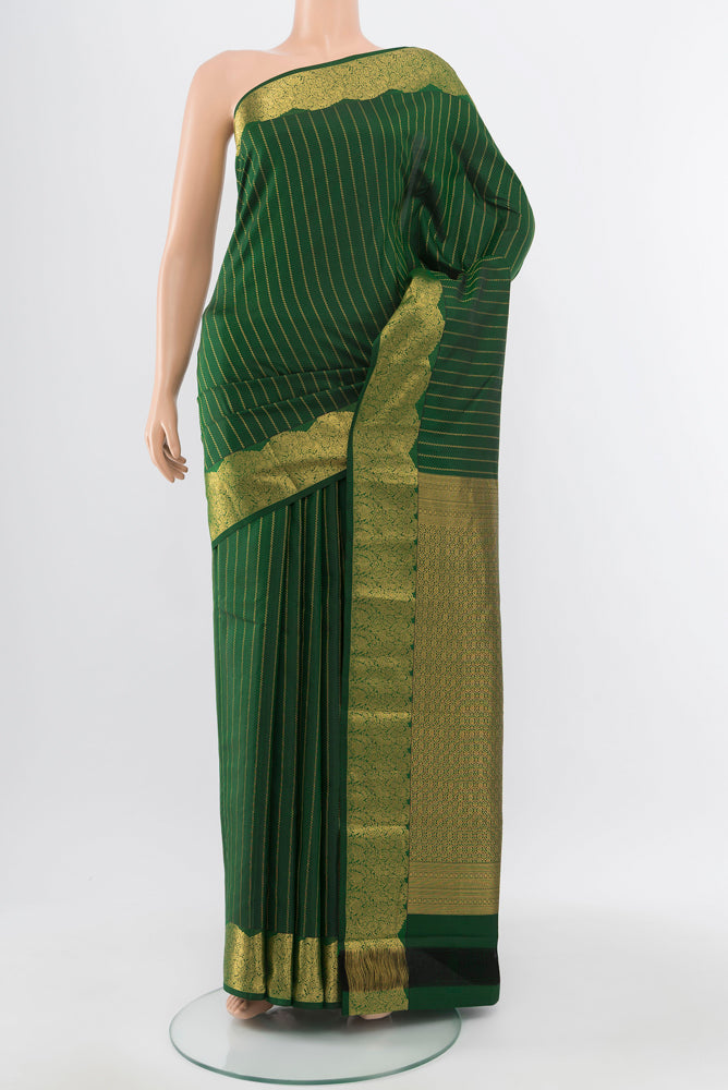 Pure Silk Pure Zari Bottle Green Kanchipuram Saree with Zari Butta on the body and Silk Border.  displayed on a mannequin